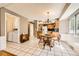 Open kitchen and dining area featuring white tile floors and wood accents, perfect for casual dining at 3150 Lane Ct, Boulder, CO 80305