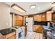 Functional kitchen with wood cabinets, black countertops, and white appliances, offering ample storage space at 3150 Lane Ct, Boulder, CO 80305
