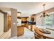 Bright kitchen featuring wood cabinets, dark countertops, and white tile flooring, adjacent to the dining area at 3150 Lane Ct, Boulder, CO 80305