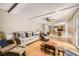 Bright living room with wood floors, a beamed ceiling, and access to the kitchen at 3150 Lane Ct, Boulder, CO 80305