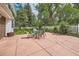 Outdoor patio area with a dining table set, surrounded by a well-manicured lawn and lush greenery at 3150 Lane Ct, Boulder, CO 80305