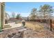 Wide shot of the backyard with multiple seating areas, a grill, and greenry at 6348 Westview Cir, Parker, CO 80134