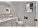 Well-lit half bath featuring modern fixtures and a gray vanity at 6348 Westview Cir, Parker, CO 80134