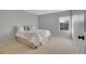 Neutral-toned bedroom with carpet, queen bed, soft grey bedding, and a large window at 6348 Westview Cir, Parker, CO 80134