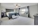 Spacious main bedroom featuring a ceiling fan and large windows with neutral carpet at 6348 Westview Cir, Parker, CO 80134