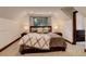 Serene bedroom featuring soft lighting, comfortable bedding, and tranquil forest views at 30221 Marge Ln, Evergreen, CO 80439