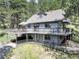 Beautiful multi-level deck offers outdoor living space with surrounding mountain views on this two-story home at 30221 Marge Ln, Evergreen, CO 80439