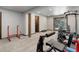 Home gym with free weights, workout bench, and access to the outside via sliding glass door at 30221 Marge Ln, Evergreen, CO 80439