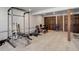 The home gym features wood trim, multiple workout machines and plenty of space to move at 30221 Marge Ln, Evergreen, CO 80439