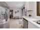 Modern kitchen featuring stainless steel appliances, white cabinets, and a view into the living area at 30221 Marge Ln, Evergreen, CO 80439