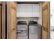 Convenient laundry room with modern washer and dryer units, and extra storage space at 30221 Marge Ln, Evergreen, CO 80439