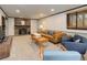 Cozy living room with a stone fireplace, leather sofa, wood table and soft carpeting at 30221 Marge Ln, Evergreen, CO 80439