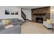 Cozy living room showcasing a stone fireplace, plush seating, and modern decor with lots of light at 30221 Marge Ln, Evergreen, CO 80439