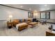 Living room has carpet, leather couch, wood coffee table, and is illuminated by recessed lighting at 30221 Marge Ln, Evergreen, CO 80439