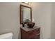 The powder room has a wooden vanity with copper vessel sink and stone counter-top at 30221 Marge Ln, Evergreen, CO 80439