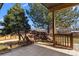 Charming backyard featuring a decorative rock feature, mature trees, and a lovely patio area at 900 S Webster St, Lakewood, CO 80226