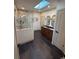 Bathroom featuring a glass shower, dual vanities, tile flooring, and a skylight providing natural light at 900 S Webster St, Lakewood, CO 80226