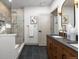 Bathroom featuring a glass shower, double sink, and modern hardware at 900 S Webster St, Lakewood, CO 80226