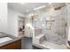 Bright bathroom features a tiled shower with a bench and a glass door, next to a wood vanity at 900 S Webster St, Lakewood, CO 80226