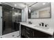 Modern bathroom with double vanity sinks, herringbone tile shower, and elegant fixtures at 900 S Webster St, Lakewood, CO 80226