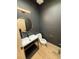 Powder room with modern light fixture, stylish vanity, and neutral color palette at 900 S Webster St, Lakewood, CO 80226