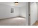 Bright, carpeted bedroom with neutral colors, a window, and a modern light fixture at 900 S Webster St, Lakewood, CO 80226