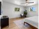 Bright bedroom with a ceiling fan, hardwood floors, and a view of the trees from the windows at 900 S Webster St, Lakewood, CO 80226