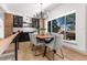 Bright dining area with a modern chandelier and a view of the yard through a large window at 900 S Webster St, Lakewood, CO 80226