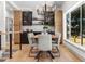 Bright dining area with a modern chandelier and a view of the yard through a large window at 900 S Webster St, Lakewood, CO 80226