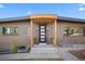 Front entrance boasts modern door with glass panels and wooden overhang at 900 S Webster St, Lakewood, CO 80226