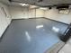 Clean and spacious garage interior featuring a sealed floor, white walls, and a side entry door at 900 S Webster St, Lakewood, CO 80226