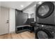 Functional laundry room with storage, utility sink, and stacked washer and dryer at 900 S Webster St, Lakewood, CO 80226