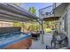 Inviting back patio features a hot tub, lounge area, and upper-level deck, perfect for outdoor relaxation and entertaining at 11760 Eudora Ct, Thornton, CO 80233