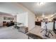 Open basement area with workout space, office, and comfortable seating at 11760 Eudora Ct, Thornton, CO 80233