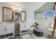 Stylish bathroom with dual vanities, decorative mirrors, and modern wood-style flooring at 11760 Eudora Ct, Thornton, CO 80233