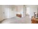 Bright bedroom with neutral walls, soft carpet, and hall access at 11760 Eudora Ct, Thornton, CO 80233