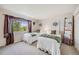 Inviting bedroom with twin beds, a large window, and decorative accents at 11760 Eudora Ct, Thornton, CO 80233