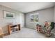 Cozy bedroom with a gray paint, well-lit, and a charming rocking chair at 11760 Eudora Ct, Thornton, CO 80233