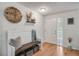 Bright and welcoming foyer with hardwood floors, stylish bench, and decorative accents at 11760 Eudora Ct, Thornton, CO 80233