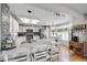 Open kitchen features a large island, stainless steel appliances, and light hardwood floors at 11760 Eudora Ct, Thornton, CO 80233