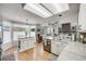 Spacious kitchen with granite counters, stainless appliances, and adjacent dining area at 11760 Eudora Ct, Thornton, CO 80233