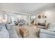 Open-concept living area with hardwood floors, comfortable seating, and stylish accents at 11760 Eudora Ct, Thornton, CO 80233
