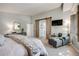 Serene main bedroom features a sliding barn door, ensuite bathroom, and accent wall at 11760 Eudora Ct, Thornton, CO 80233