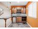 Wet bar with tiled backsplash, mini fridge, wine rack, and stylish pendant lighting for entertaining at 2028 Ulster St, Denver, CO 80238