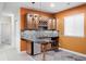 Basement wet bar with wood cabinets and granite countertop at 2028 Ulster St, Denver, CO 80238