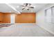 A large basement with neutral carpet, light-colored walls, and a door leading to another room at 2028 Ulster St, Denver, CO 80238