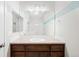 Bathroom featuring vanity with dark wood cabinets, modern fixtures, and a large mirror at 2028 Ulster St, Denver, CO 80238