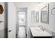 A bright bathroom with a modern sink and a view into the connected bedroom at 2028 Ulster St, Denver, CO 80238