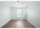 Spacious bedroom with large window and wood-look floors at 2028 Ulster St, Denver, CO 80238