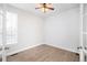 Bright, empty bedroom with hardwood floors, white walls, and french doors at 2028 Ulster St, Denver, CO 80238